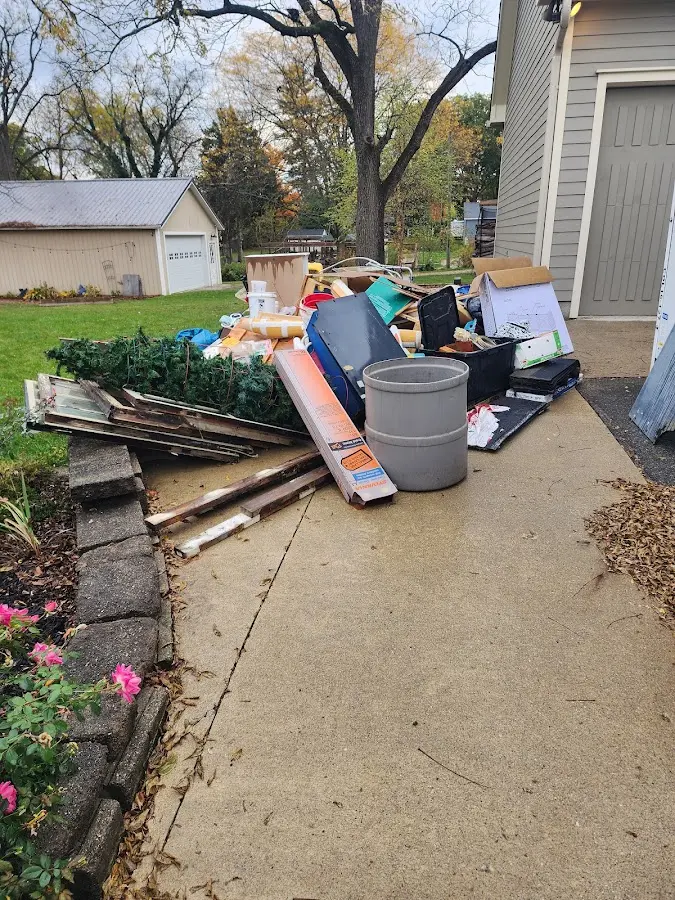 Dumpster being loaded with debris for Estate Cleanout Dumpster Rental in Diamond Springs